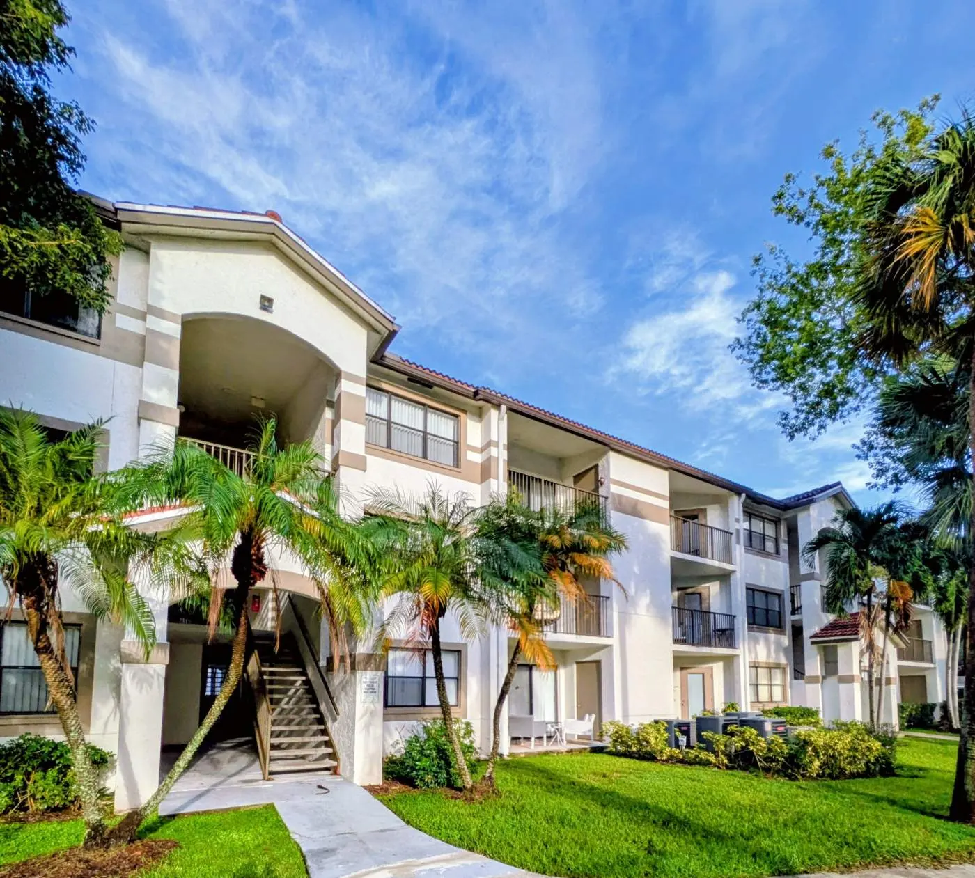 Three-story building with palms at Hollywood Parc